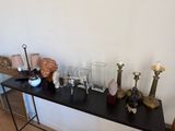 a black table with a bunch of candles and other items on it