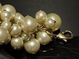 a bunch of white pearls on a black surface