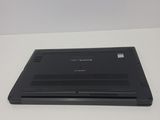 the back of a black laptop computer sitting on top of a white table