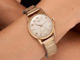 a close up of a woman ' s wrist with a watch on it