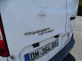 a dirty white van parked in a parking lot
