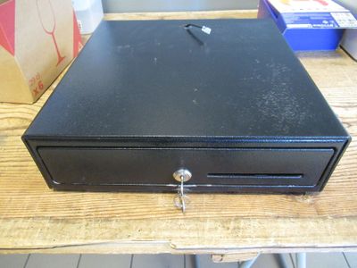 a black metal box sitting on a wooden table