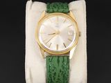 une image représentant une montre-bracelet dorée et verte, dotée d'un bracelet vert