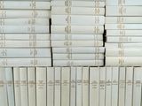 many books stacked on top of each other on a shelf