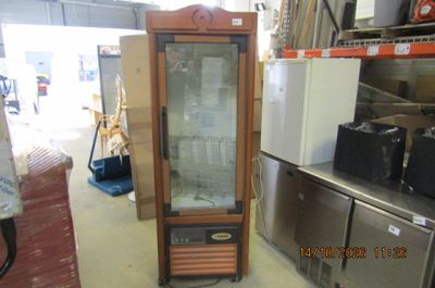 a glass display cabinet in the middle of a room