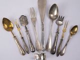 a lot of spoons and forks on the table