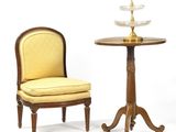 two chairs and a table with a glass bowl on top of it