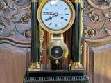 a black and gold clock sitting on a wooden table