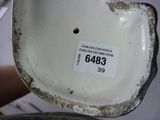 a close up of a white porcelain bowl with a tag on it