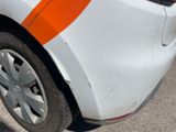 a close up of a white car with an orange stripe on it