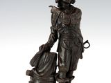 statue en bronze représentant un homme avec un seau et un chien