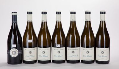 six bottles of wine are lined up in a row on a table
