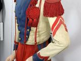 a mannequin dressed in a red and blue uniform