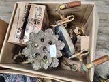 a box full of assorted items sitting on a wooden floor