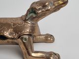 bronze figurine of a dog on a white background