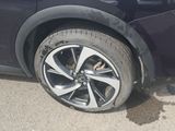 a black car with a flat tire on the street