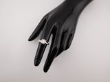 a close up of a person ' s hand with a diamond ring on it