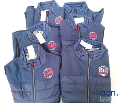 several blue vests with red and white logos on them