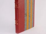 a red book with a yellow and gray stripe on it