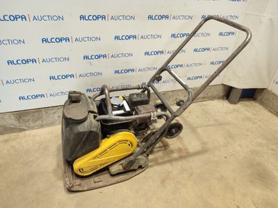 a close up of a small lawn mower with a yellow handle