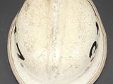 a white helmet with black arrows on it on a table