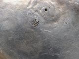 a silver plate with a hole in the middle of it