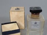two small bottles of perfume sitting next to each other on a table