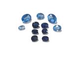 a bunch of blue sapphires on a white surface