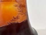 a glass bell with a picture of a sunset on it