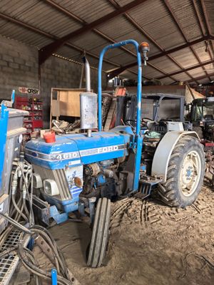 a blue tractor that is parked inside of a building