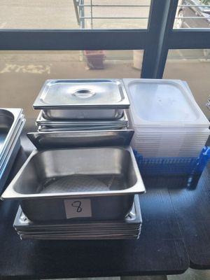 several trays of food sitting on a table in front of a window