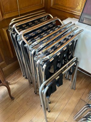 a lot of chairs in a room with a laptop on the table