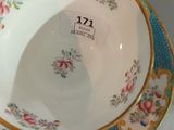 a bowl and saucer sitting on a plate on a table