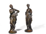 pair of bronze figurines of a woman and a man