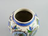 a vase with a design on it sitting on a table