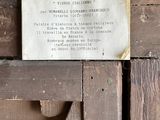 a plaque on the side of a wooden door