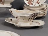 many plates and bowls on a table with a bowl and saucer