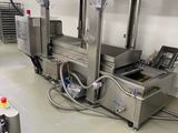 an image of a commercial kitchen with a conveyor belt
