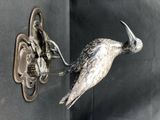 un oiseau accroché au mur à côté d'une porte