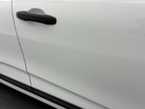 the door handle of a white car with a black handle