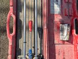 someone is standing next to a red tool box with tools in it
