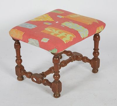a small wooden stool with a colorful seat on it
