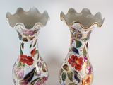 two vases that have been painted with flowers on them
