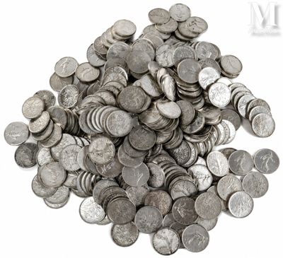 a pile of silver coins on a white surface