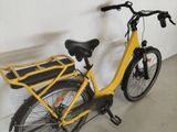 a yellow bicycle with a basket attached to it