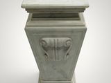 an image of a white marble pedestal with a face on it