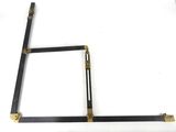 an image of a pair of black and gold square brackets on a white surface
