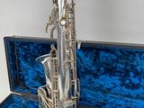 a silver saxophone in a blue case on a white background