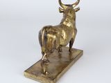 brass statue of a bull on a marble base on a white background