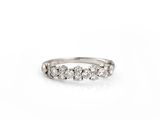 a close up of a diamond ring on a white background